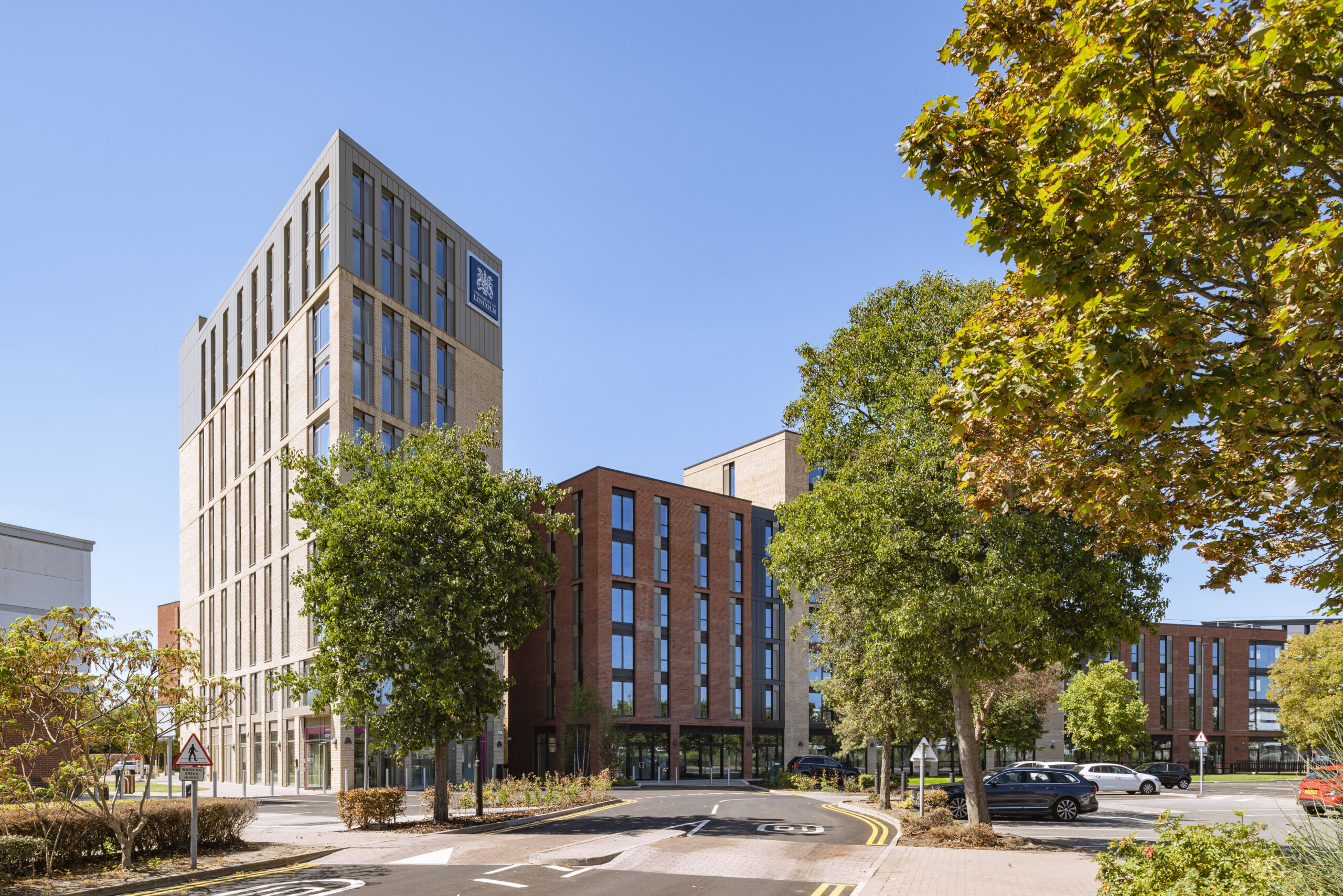 Project photo of Lincoln St. Marks new student accommodation buildings alongside an avenue of trees
