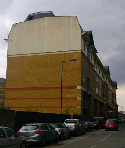 Pre-redevelopment side perspective of the beige industrial-style Wenlock Works building in Old Street.