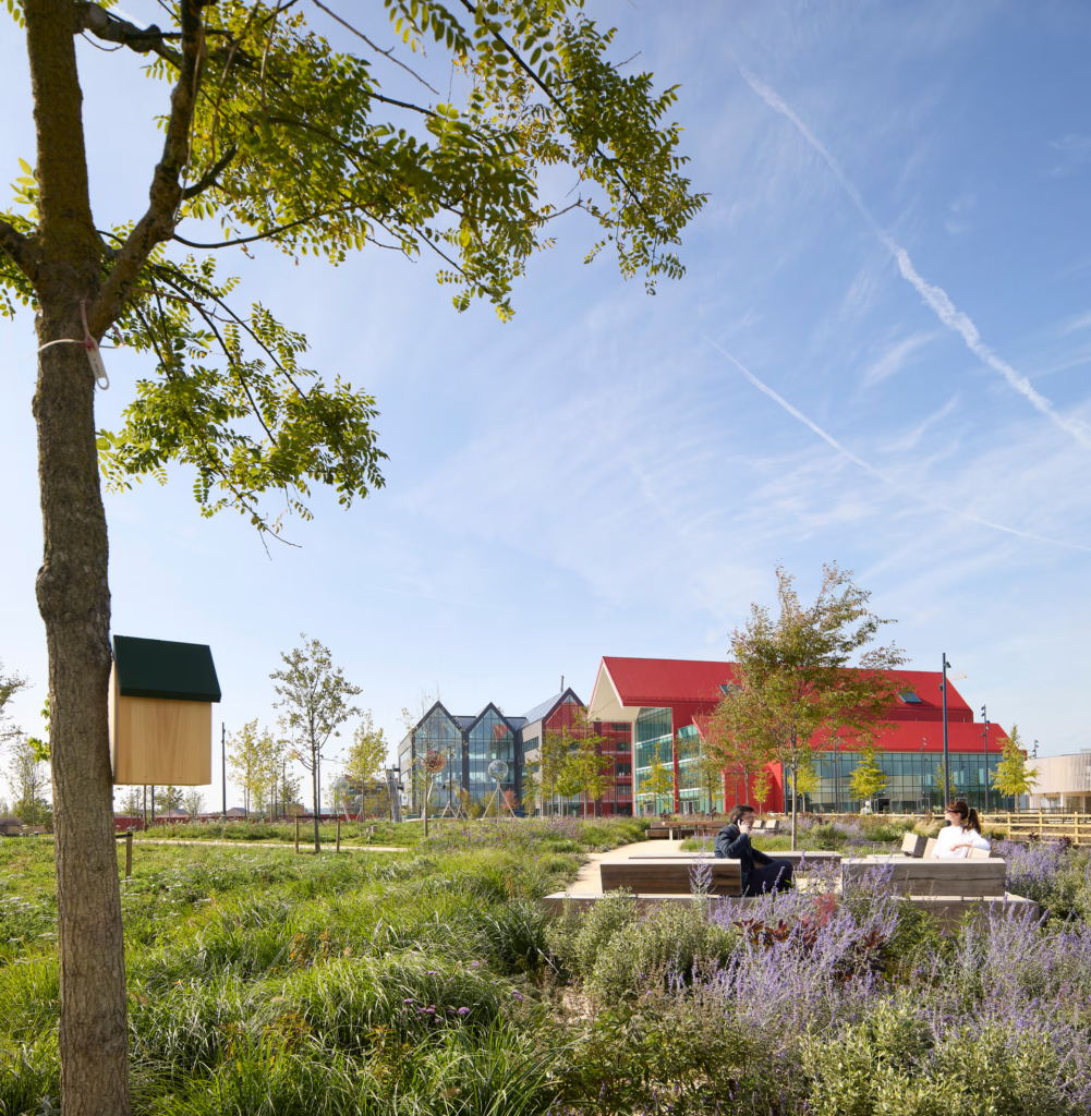 Oxford-North-CGI-green-space-with-the-red-hall-in-the-background-Credit-Stanhope